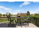 Relaxing deck space with wrought iron table and chairs overlooking a lake at 4373 E Phillips Pl, Centennial, CO 80122