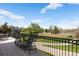 Outdoor deck area with wrought iron furniture and a view of the golf course at 4373 E Phillips Pl, Centennial, CO 80122