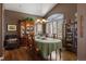 Formal dining room with hardwood floors, elegant lighting, and a large window at 4373 E Phillips Pl, Centennial, CO 80122
