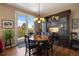 Dining room with hardwood floors, stylish chandelier, and access to the balcony at 4373 E Phillips Pl, Centennial, CO 80122