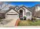 Charming home featuring a well-manicured lawn, two-car garage and neutral colored stucco facade at 4373 E Phillips Pl, Centennial, CO 80122