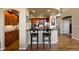 A kitchen features granite countertops, wooden cabinetry, and bar stool seating at the island at 4373 E Phillips Pl, Centennial, CO 80122