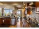 Open-concept kitchen featuring granite countertops, stainless steel appliances, and wooden cabinetry at 4373 E Phillips Pl, Centennial, CO 80122