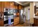This kitchen features wooden floors, granite counters and stainless steel appliances at 4373 E Phillips Pl, Centennial, CO 80122
