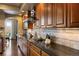 A gourmet kitchen features granite countertops, tiled backsplash, and wooden cabinetry at 4373 E Phillips Pl, Centennial, CO 80122