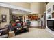 Open-concept living area with high ceilings, lots of light, and a view to the kitchen at 4373 E Phillips Pl, Centennial, CO 80122