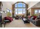 Spacious living room with high ceilings, large windows, and elegant furnishings at 4373 E Phillips Pl, Centennial, CO 80122
