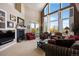 Bright and airy living room with fireplace, high ceilings, and scenic views at 4373 E Phillips Pl, Centennial, CO 80122