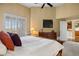 A bedroom offers high ceilings, shutters on windows, and an adjacent bathroom and kitchen at 4373 E Phillips Pl, Centennial, CO 80122