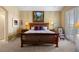 Spacious main bedroom with a wooden bed frame, neutral color scheme, and natural light at 4373 E Phillips Pl, Centennial, CO 80122
