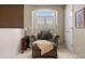 Cozy sitting area with window, chair, ottoman, and door, bathed in natural light at 4373 E Phillips Pl, Centennial, CO 80122