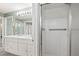 Bathroom featuring double sinks, a full mirror, and a walk-in shower at 9004 E Floyd Ave, Denver, CO 80231