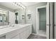 Bathroom featuring double sinks, a full mirror, and a separate shower area at 9004 E Floyd Ave, Denver, CO 80231