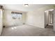 Bedroom featuring carpet flooring, natural light, and easy access to hallway at 9004 E Floyd Ave, Denver, CO 80231