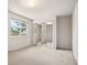 Bedroom featuring carpet flooring, natural light, and a mirrored closet at 9004 E Floyd Ave, Denver, CO 80231