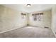Bright bedroom with carpet flooring, natural light, and neutral-toned walls at 9004 E Floyd Ave, Denver, CO 80231