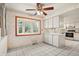 Cozy breakfast nook with a bright bay window and white cabinets for convenient storage at 9004 E Floyd Ave, Denver, CO 80231