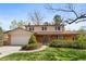 Charming two-story home with well-manicured lawn and mature landscaping adding to its curb appeal at 9004 E Floyd Ave, Denver, CO 80231