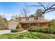 Charming two-story home with well-manicured lawn and mature landscaping adding to its curb appeal at 9004 E Floyd Ave, Denver, CO 80231