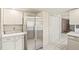 Bright kitchen featuring stainless steel refrigerator, ample counter space, and convenient pantry at 9004 E Floyd Ave, Denver, CO 80231