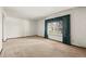 Spacious living room featuring neutral carpet, large window, and ample natural light at 9004 E Floyd Ave, Denver, CO 80231
