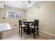 Cozy dining area with a round table and four chairs, illuminated by a ceiling fan and natural light at 1310 S Carson Way, Aurora, CO 80012