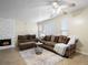 Comfortable living room featuring dual sofas, hardwood floors, and a fireplace with bright, natural light at 1310 S Carson Way, Aurora, CO 80012