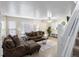 Bright living room featuring an open staircase, hardwood flooring, and a comfortable seating arrangement at 1310 S Carson Way, Aurora, CO 80012