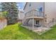 A home with lush green lawn and fenced backyard with a wooden deck at 2229 Hyacinth Rd, Highlands Ranch, CO 80129