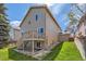 A home with lush green lawn and fenced backyard with a wooden deck at 2229 Hyacinth Rd, Highlands Ranch, CO 80129