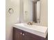 Bathroom featuring a single vanity with a white sink, dark cabinets, and brushed nickel hardware at 2229 Hyacinth Rd, Highlands Ranch, CO 80129