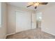 Carpeted bedroom with ceiling fan and closet for comfort and storage at 2229 Hyacinth Rd, Highlands Ranch, CO 80129