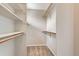 Walk-in closet with shelving and wooden hanging rods at 2229 Hyacinth Rd, Highlands Ranch, CO 80129