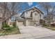 Two-story home featuring a two car garage and well-maintained lawn, with a blue sky at 2229 Hyacinth Rd, Highlands Ranch, CO 80129