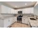Bright kitchen featuring white cabinetry, stainless appliances, and granite countertops at 2229 Hyacinth Rd, Highlands Ranch, CO 80129