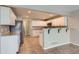 Bright kitchen featuring white cabinetry, stainless appliances, granite countertops, and breakfast bar at 2229 Hyacinth Rd, Highlands Ranch, CO 80129