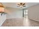 Bright living area with tile flooring, a ceiling fan, and sliding glass door access to a patio at 2229 Hyacinth Rd, Highlands Ranch, CO 80129