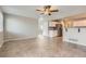 Open-concept living area with tile flooring, a ceiling fan and adjacent kitchen at 2229 Hyacinth Rd, Highlands Ranch, CO 80129