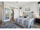 Main bedroom featuring a sliding barn door and a calming color scheme at 16070 Misty Rain Ct, Monument, CO 80132