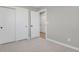 Bedroom featuring soft carpet, and multiple closets with passage door access at 4750 E Louisiana Ave, Denver, CO 80246