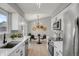 Modern kitchen with white cabinets, stainless steel appliances and breakfast nook at 4750 E Louisiana Ave, Denver, CO 80246