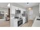 Open concept kitchen boasts stainless steel appliances and a view into the living room at 4750 E Louisiana Ave, Denver, CO 80246