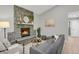 Cozy living room featuring a stone fireplace and hardwood floors at 4750 E Louisiana Ave, Denver, CO 80246