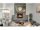 Living room with a large stone fireplace, hardwood floors, and stylish decor at 4750 E Louisiana Ave, Denver, CO 80246