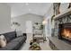 Bright living room features a stone fireplace and lots of natural light at 4750 E Louisiana Ave, Denver, CO 80246