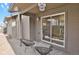 Relaxing patio area with two black chairs and sliding glass door access at 4750 E Louisiana Ave, Denver, CO 80246