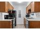 Modern kitchen with dark wood cabinets, black appliances, and grey countertops at 14780 E Kentucky Dr # 414, Aurora, CO 80012