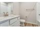 Bright bathroom features a single sink with a white quartz countertop and modern gold fixtures at 4334 Gozzer Ranch Dr, Elizabeth, CO 80107
