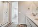 Modern bathroom featuring double sink vanity, tiled shower, and wood look flooring at 4334 Gozzer Ranch Dr, Elizabeth, CO 80107
