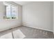 A bright bedroom with gray carpet and a window that offers scenic views at 4334 Gozzer Ranch Dr, Elizabeth, CO 80107